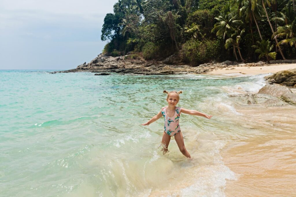 Little girl playing on beach