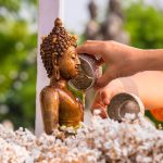 Pouring water over Buddha during Songkran