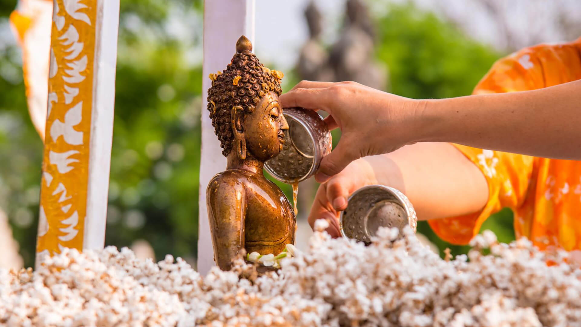 Pouring water over Buddha during Songkran